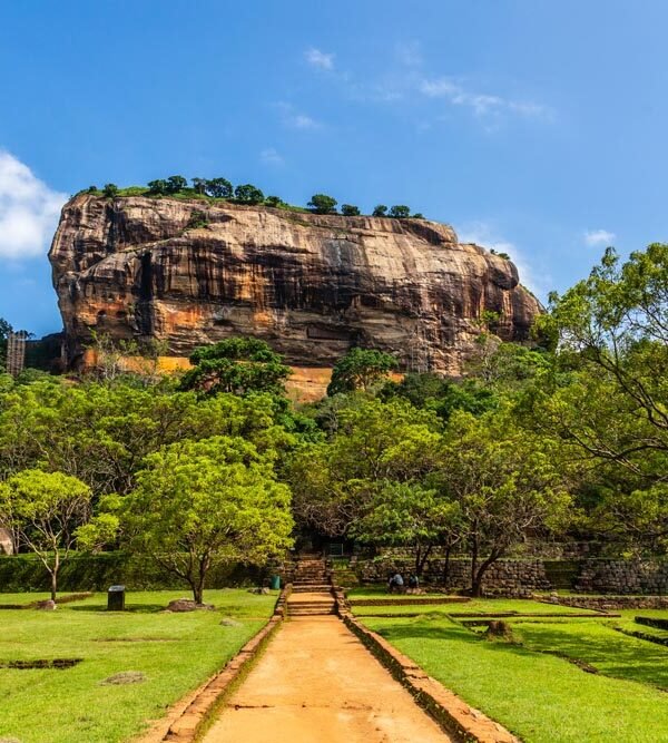 Sigiriya: Majestic rock fortress rising above lush landscapes, a UNESCO World Heritage Site beckoning with ancient history and breathtaking vistas.